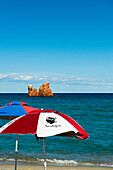  Beach umbrellas and red rocks, Spiaggia di Cea, Tortoli, Sardinia, Italy 