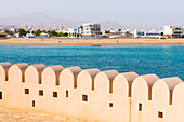 Crenelated wall protecting the lighthouse at Al Ayjah village, Sur Township, port-city, capital of Ash Sharqiyah Region, Sultanate of Oman, Arabian Peninsula, Middle East