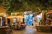 Café terrace and tailor shops at night in the old town of Nizwa, Ad Dakhiliyah Region, Sultanate of Oman, Arabian Peninsula, Middle East