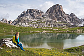 young woman resting by one of the Laghi dei Plani (Plains Lakes), Three Peaks nature park, Trentino-Alto Adige, Sudtyrol, South Tyrol, Italy, South-central Europe