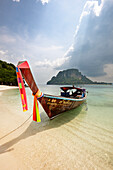 Traditional Thai long-tail boat moored at the beach on Tup Island, aka Tub Island, Koh Tap or Koh Thap. Krabi Province, Thailand.