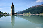 Kirchturm aus dem überfluteten Alt-Graun ragt aus dem Reschensee (Lago di Resia) am Reschenpass, Vinschgau, Südtirol, Italen, Alpen, Europa