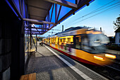 Tram passes modern train station in Karlsruhe Hagsfeld, public transport project regiomove, Baden-Württemberg, Germany 