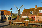  Traditional houses and windmill of the inhabited former fortress Bourtange, Groningen, Netherlands  