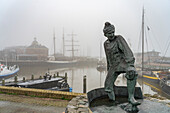  Sculpture The Tobbedanser at the foggy harbor of Harlingen, Friesland, Netherlands  