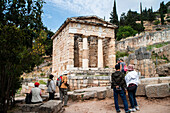 Tourists visiting  the Treasuries archaeological site in Delphi,. Greece