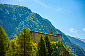 Beautiful Castle with Mountain View in a Mountain Valley in the Swiss Alps in a Sunny Summer Day with Blue Sky and Clouds and Castle, Castello Di Mesocco in Mesocco, Grisons, Switzerland.