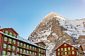The Famous and Historical Hotel Bellevue des Alpes at 2061 Meters High Up and Mountain Peak of North Face of Eiger 3907 Meter High in a Sunny Winter Day in Kleine Scheidegg, Grindelwald, Canton Bern, Switzerland.
