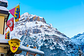 House and Mountain Range in a Snowy Winter Day in Grindelwald, Canton Bern, Switzerland.