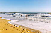 Sandstrand, Badende und Fishing Pier in Virginia Beach, Princess Anne County, Virginia, USA