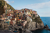 Summer View of buildings on rock in Manarola, Cinque Terre, Italy
