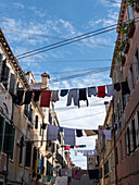 Street in Venice showing intersecting laundry lines, Italy