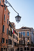 Steet and building facades and lamp in Venice, Italy