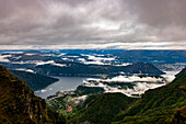 Beautiful Aerial View over City and Lake Lugano and Swiss Alps with Clouds in a Cloudy Day in Autumn in Lugano, Ticino, Switzerland.