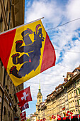 Beautiful Old City Street with Old Building and Flags in a Sunny Summer Day in City of Bern, Canton Bern, Switzerland.