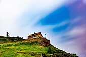 Beautiful Hotel on Mountain Peak with Beautiful Sky with Clouds in Alp Grüm in a Summer Day in Poschiavo, Bernina, Grisons, Switzerland.