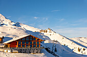 Ski Slope with Overhead Cable Car and Restaurant at 2000 Meters High Up and Mountain Peak in a Sunny Winter Day with Blue Sky in Kleine Scheidegg, Bernese Oberland, Grindelwald, Canton Bern, Switzerland.