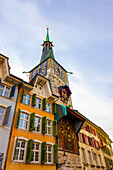 The Zeitglockenturm Clock Tower and Colorful House Facades on the Market Square in the Heart of the Baroque Old Town with Sunlight in a Sunny Autumn Day in Solothurn, Canton Solothurn, Switzerland.