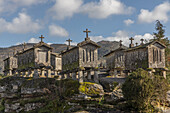  Old stone granaries, Granaries of Soajo, stand high against a mountain backdrop, Viana do Castelo, Soajo, Portugal 
