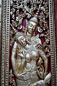 Silver-plated low relief on the outside doors of Hohng Kep Mien, the royal funerary carriage house, at Buddhist temple Wat Xieng Thong, Luang Prabang, Laos, Southeast Asia