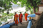 Novice monks on stairs leading to a huge footprint of the Buddha by the Mekong River, Wat Pha Baht Tai (Pha Phutthabaht, Phutthabat Tai, Tha Pha Hak) monastery, Luang Prabang, Laos, Southeast Asia