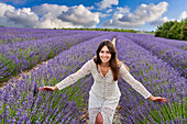Young girl 30-35 years old, Cultivation of Lavender, Lavender in bloom, Valensole, Alpes-de-Haute-Provence, Provence-Alpes-Côte d'Azur, France, Europe