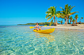 Woman sea kayaking in Fiji islands turquoise water, Waya island, Yasawa islands, Fiji