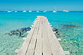Wooden pier leading to Formentera island turquoise waters, Formentera, Balearic Islands, Spain