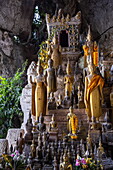  Hundreds of miniature Buddha sculptures adorn the lower cave in the Pak Ou Caves, Pak Ou, Pak Ou District, Luang Prabang, Laos, Asia 