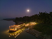  Aerial view of the boutique river cruise ship Anouvong (Heritage Line) anchored at dusk on a sandbar on the Upper Mekong River, with barbecue dinner and a full moon, near Pak Lay, Xanakharm, Vientiane Province, Laos, Asia 