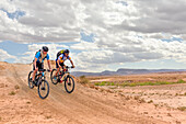 Riders on mountain bike with electric assistance on a track between Ouarzazate and Ait Ben Haddou, Ounila River valley, Ouarzazate Province, region of Draa-Tafilalet, Morocco, North West Africa