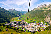 Beautiful Panoramic View From Overhead Cable Car over New and Old Cityscape and Golf Course with Mountainscape and Mountain Valley in a Sunny Summer Day in Andermatt, Uri, Switzerland.
