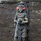 Intricately carved fountain statue at Saraswati Temple (Pura Taman Saraswati), aka Ubud Water Palace. Ubud, Bali, Indonesia.