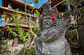 Intricately carved stone statue in the garden at Hotel in Ubud, Bali, Indonesia.