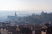 View of the Old Prague areas from the top in misty morning