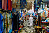  Covered souk with textiles, bags and handicrafts in the Medina in Hammamet, Tunisia 