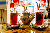  Arabic-style peppermint tea with pine nuts, served with a silver teapot in a Tunisian café in the souk in Nabeul, Tunisia 