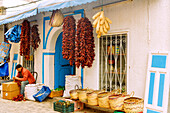  Dried piment de baklouti (baklouti pepper, chili pepper) for making harissa and wicker baskets at a shop in the souk in the medina in Nabeul, Tunisia 