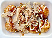 Takoyaki (octopus, green onion, ginger, and batter snack, Osaka, Japan\n