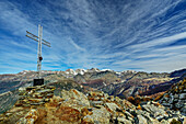  Summit cross of Monte Palino with Bernina in the background, Monte Palino, Bergell, Bernina Range, Lombardy, Italy 