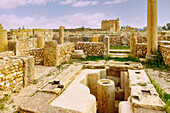  Baptistery and baptismal font with view of the Temple of Jupiter, Minerva and Juno, archaeological site with the ruins of the Roman Sufetula, in Sbeitla, Tunisia 