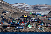  View of the colorful houses of the village, nestled in the valley and over the hills, Ittoqqortoormiit, East Greenland, Greenland Europe 