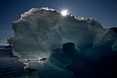  Backlit view of a semi-transparent iceberg with star effect sun, near Vikingebugt, East Greenland, Greenland Europe 