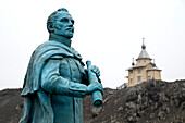  A statue of Fabian Gottlieb von Bellingshausen and an Orthodox chapel stand on the Russian Bellingshausen Station, King George Island, South Shetland Islands, Antarctica 