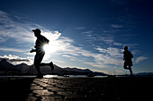  Two marathon runners pass the camera during a popular marathon race event, Ushuaia, Patagonia, Argentina, South America 