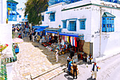  Main street Rue Habib Thameur with souvenir shops and white cube houses with Arabic balconies in the (Medina) old town of Sidi Bou Said, Tunisia 
