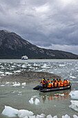  Zodiac inflatable boat transports passengers to the expedition cruise ship Stella Australis (Australis Cruises) near Pio X Glacier, Eyre Inlet, Chilean Fjords, Magallanes and Chilean Antarctica, Patagonia, Chile, South America 