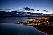  Edge of the infinity whirlpool at Arakur Ushuaia Resort and Spa overlooking the city lights at dusk, Ushuaia, Tierra del Fuego, Patagonia, Argentina, South America 