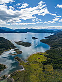  Aerial view of Zodiac inflatable boats transporting passengers of the expedition cruise ship Ventus Australis (Australis Cruises) for a hiking excursion in Wulaia Bay, Isla Navarino, Cape Horn, Magallanes and Chilean Antarctica, Patagonia, Chile, South America 