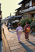 Women in traditional kimono walking on a cobbled street in the Higashiyama district, Kyoto, Japan